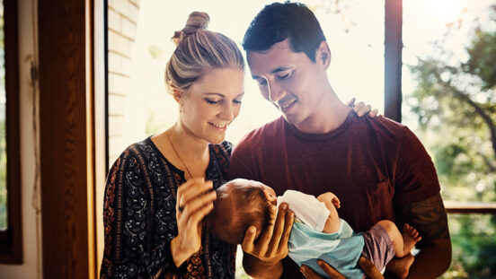 Shot of young parents bonding with their newborn baby boy at home - Summer Australia