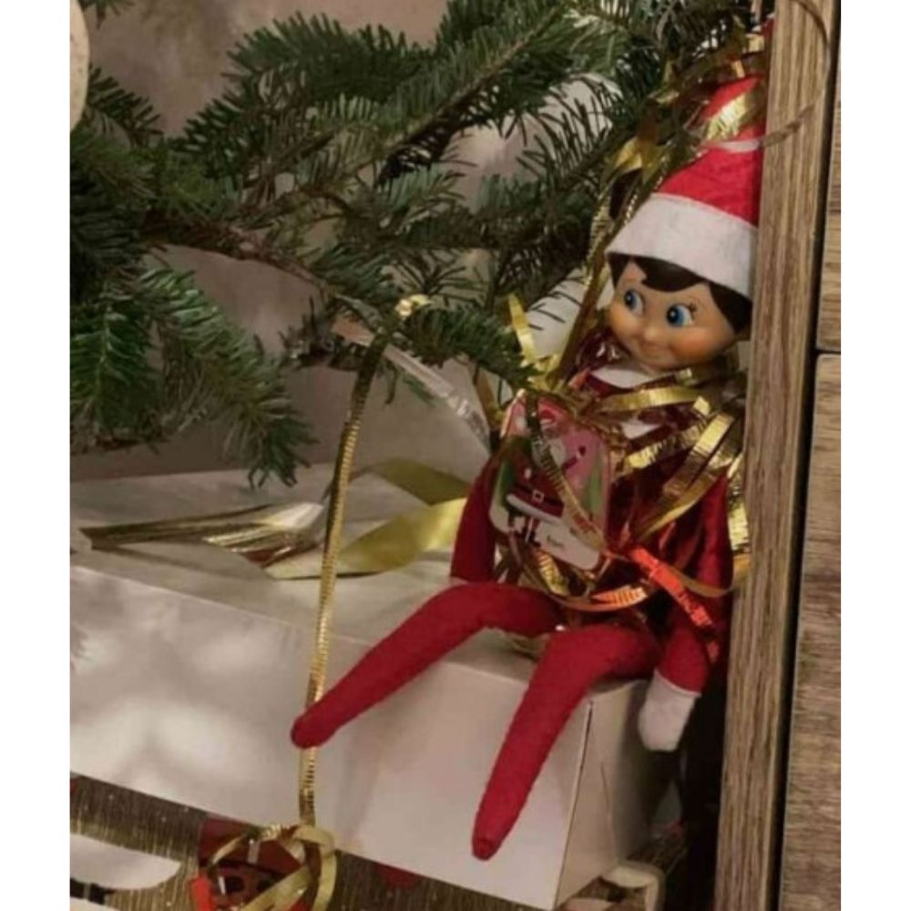 Elf on a shelf tangled in tinsel