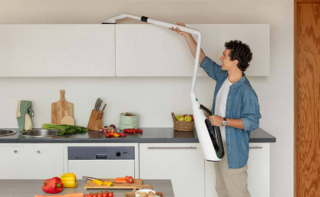 Man used Thermomix Kobold Vac mop attachment to clean top of kitchen cupboards.