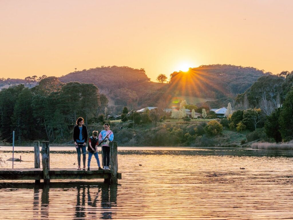 Family fishing off jetty at Lake Sambell, Beechworth