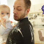 Dad holding baby, both covered in yoghurt