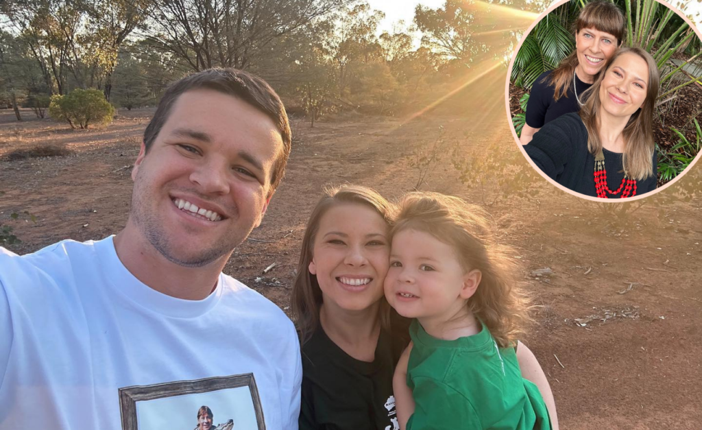 Chandler wearing a Crocodile Hunter t-shirt, taking a selfie in the bush with Bindi and Grace