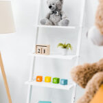 modern interior of nursery room with rack and toys