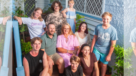 Australian mum, Jeni Bonell and family pose on porch steps.