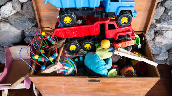 Outdoor toy box staxked high with children's toys.