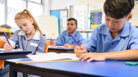 School children in classroom doing work