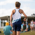 Adolescent boy at a community running event