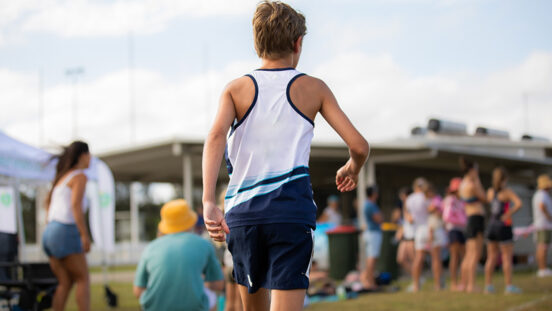 Adolescent boy at a community running event