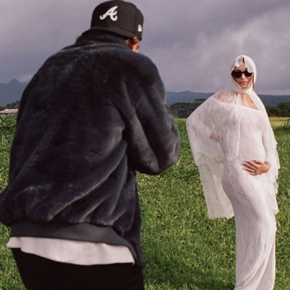 Justin and Hailey Bieber pregnancy announcement photos - Hayley in white wedding dress with Justin taking photos of her