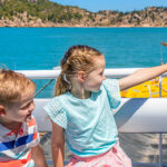 Young brother and sister on boat heading to Magnetic Island Townsville