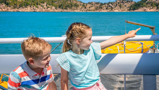 Young brother and sister on boat heading to Magnetic Island Townsville