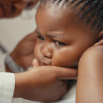 Shot of an adorable little girl having her ears checked during a consultation with a doctor