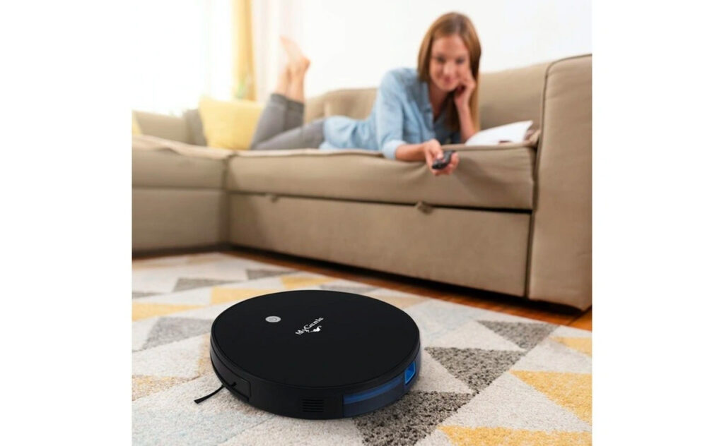 Woman lays on lounge while MYGENIE XSonic Robotic Vacuum Cleaner cleans her living room floors
