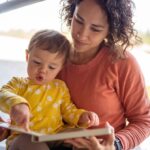 mother reading book with adorable toddler