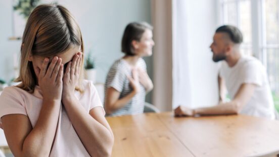 ittle girl, daughter suffers from her parents fighting, quarrelling, screaming, sorting their relations at home.