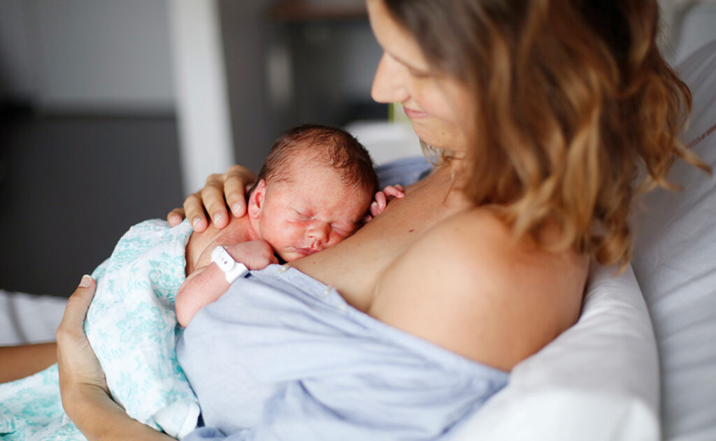 A newborn and his mother at maternity ward.