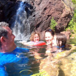 Australian family having fun at Wangi Falls in Litchfield National Park in the Northern Territory of Australia