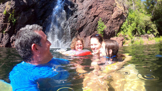 Australian family having fun at Wangi Falls in Litchfield National Park in the Northern Territory of Australia