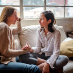 Mother and daughter at home having a talk at home