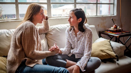 Mother and daughter at home having a talk at home