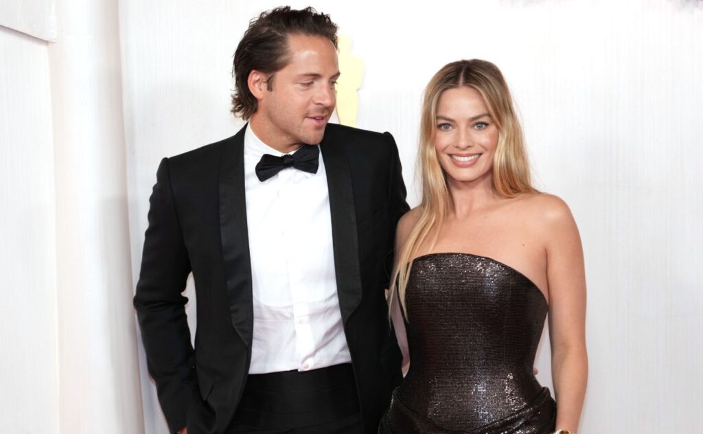 Tom Ackerley and Margot Robbie attend the 96th Annual Academy Awards 