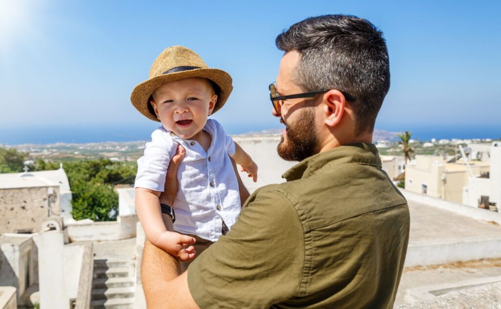 Greek baby names: Father and little son walking on the island of Santorini