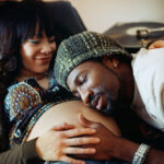 Man Feeling a Pregnant Woman's Stomach