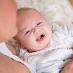 Baby's cold checklist: mother taking crying baby's temperature