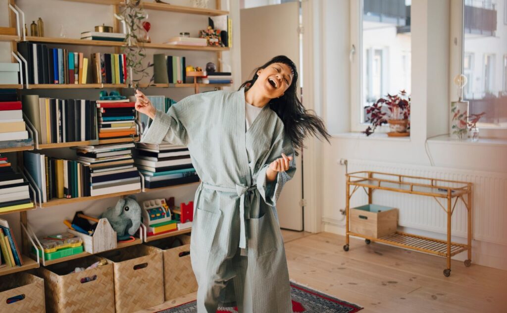 woman enjoying while dancing at home in living room