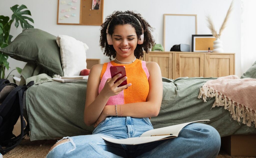 Social media ban: Teenage girl on her phone in bedroom