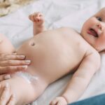 Nappy rash care: Mother applies nappy rash cream to baby