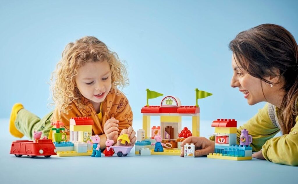 Mother play LEGO Duplo with child