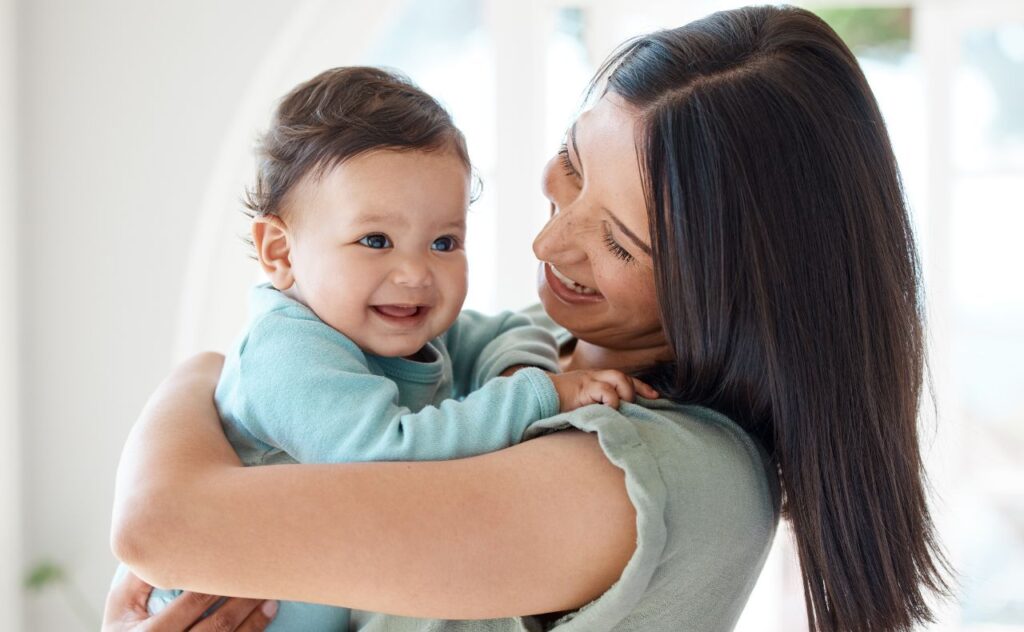 Mother's Day gift guide: mother smiling with her baby at home