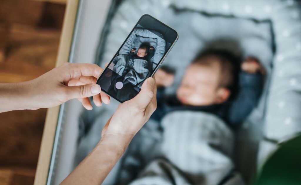 Mother taking photo of baby with a smartphone