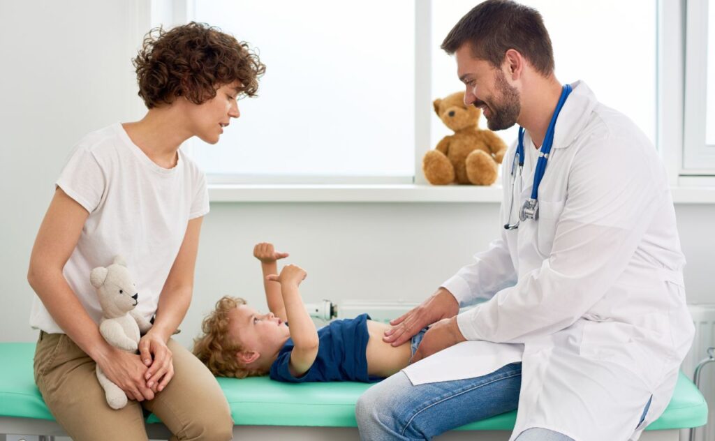 Sore tummy: Mother with young boy who is seeing a doctor for a tummy ache