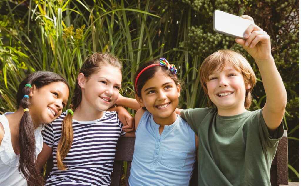Parenting in a digital age: Four friends taking a selfie