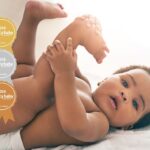 Best baby wipes fragrance: Cute baby with nappy on and legs in the air