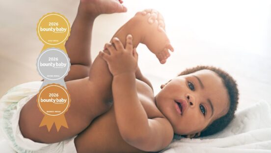 Best baby wipes fragrance: Cute baby with nappy on and legs in the air