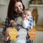 BBA best steriliser. Mother holding baby in kitchen