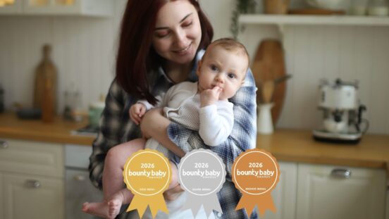 BBA best steriliser. Mother holding baby in kitchen