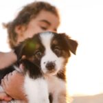 Gifts for pets: Girl holding puppy