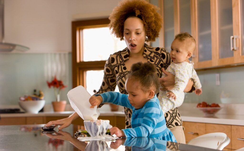 Stress about mess. Mother with baby and toddler and mess at home