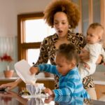 Stress about mess. Mother with baby and toddler and mess at home