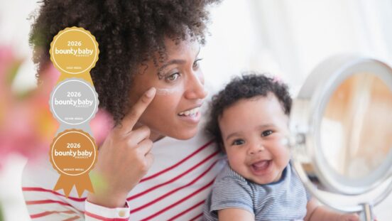 Best skincare products for mums: Mother holding baby and applying moisturising cream