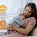 Best nursery accessory: Mother cuddling newborn in nursery