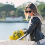 When Mother's Day is hard. Woman looking sad while holding yellow flowers.