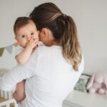 Mother with baby in nursery: Parenting and baby products