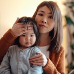 Cold and flu season: Expert tips. Asian mother with toddler who has a fever