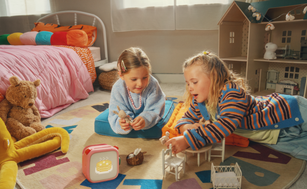 Girls playing in bedroom listening to Yoto