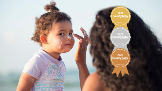 Mum applying suncreen to toddler daughter. The best sunscreen for keeping the whole family covered